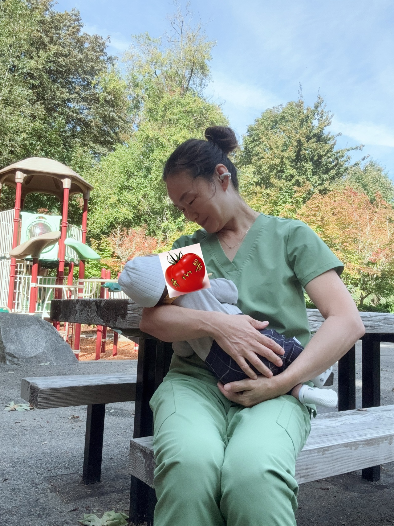 Zhengfang Wang caring for a baby outdoors